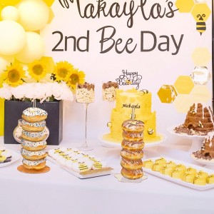 An acrylic stand filled with donuts is placed on the table