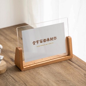 Sign holder with wooden base for home photo frame placed on table